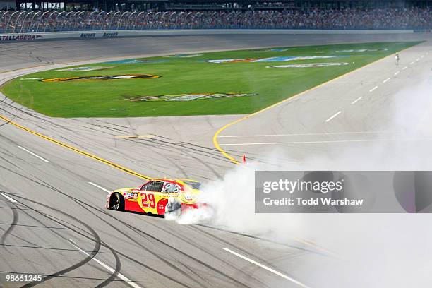 Kevin Harvick, driver of the Shell/Pennzoil Chevrolet, does a burnout on track after winning the NASCAR Sprint Cup Series Aaron's 499 at Talladega...