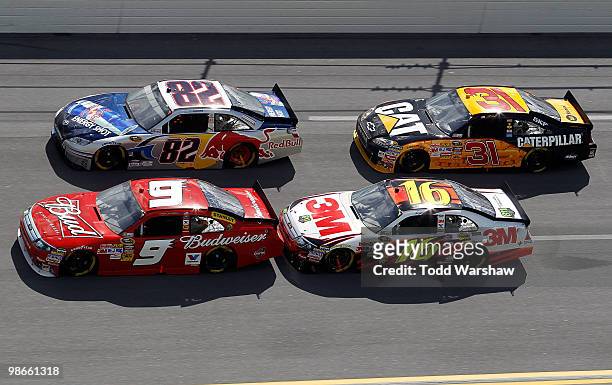 Scott Speed, driver of the Red Bull Toyota, races Kasey Kahne, driver of the Budweiser Ford, Greg Biffle, driver of the 3M Ford, and Jeff Burton,...