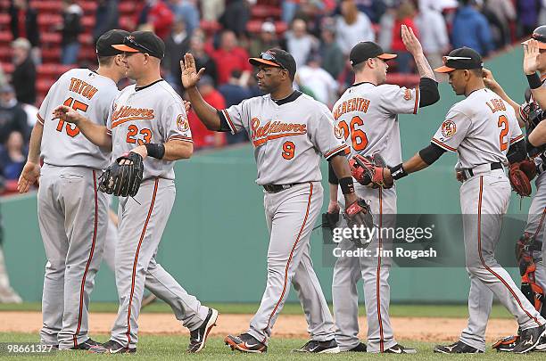 Miguel Tejada of the Baltimore Orioles celebrates with his teammates after defeating the Boston Red Sox, 7-6, in 10 innings at Fenway Park on April...