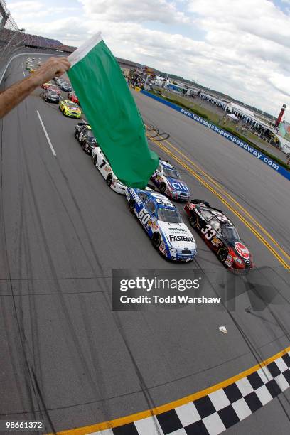 Kevin Harvick, driver of the Rheem Chevrolet, and Carl Edwards, driver of the Fastenal Ford, lead the field to the green flag to start the NASCAR...