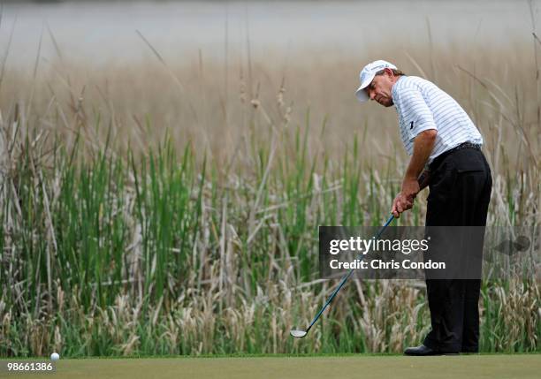 Nick Price of Zimbabwe putts for birdie on the 13th green during the final round of the Legends Division at the Liberty Mutual Legends of Golf at The...