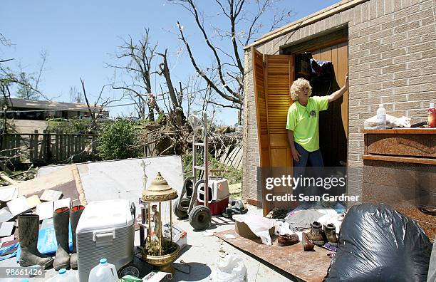 Angie Page removes rest for a moment while attempting to salvage clothing from her boyfriends home on April 25, 2010 in Yazoo City, Mississippi. On...