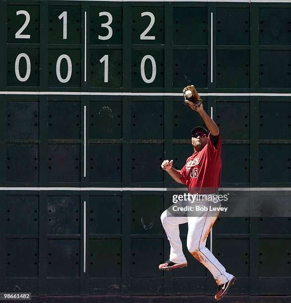 Left fielder Carlos Lee of the Houston Astros makes leaping cartch at the wall on a line drive by Garrett Jones of the Pittsburgh Pirates in the...