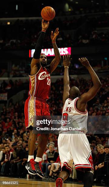 LeBron James of the Cleveland Cavaliers puts up a three point shot over Luol Deng of the Chicago Bulls on his way to a game-high 37 points in Game...