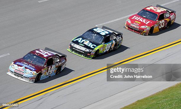 Tony Stewart, driver of the Olds Spice Matterhorn Chevrolet, leads Carl Edwards, driver of the Aflac Ford, and Clint Bowyer, driver of the BB&T...