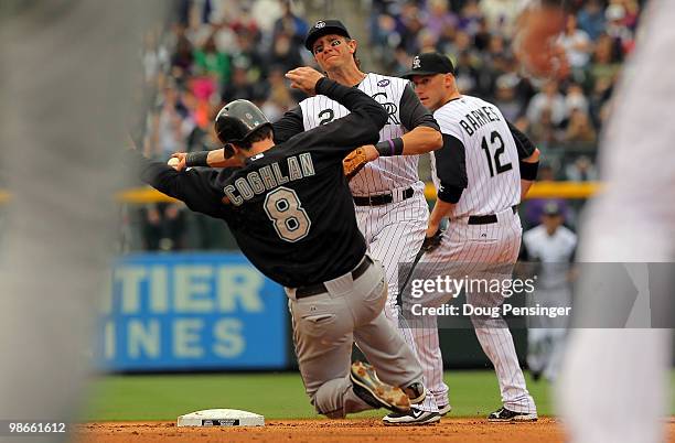 Shortstop Troy Tulowitzki of the Colorado Rockies turns a double play on Chris Coghlin of the Florida Marlins on a grounder hit by Gaby Sanchez to...