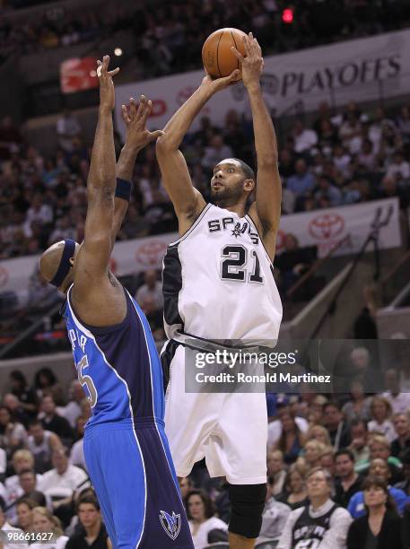 Forward Tim Duncan of the San Antonio Spurs takes a shot against Erick Dampier of the Dallas Mavericks in Game Four of the Western Conference...