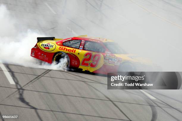 Kevin Harvick, driver of the Shell/Pennzoil Chevrolet, does a burnout on track after winning the NASCAR Sprint Cup Series Aaron's 499 at Talladega...