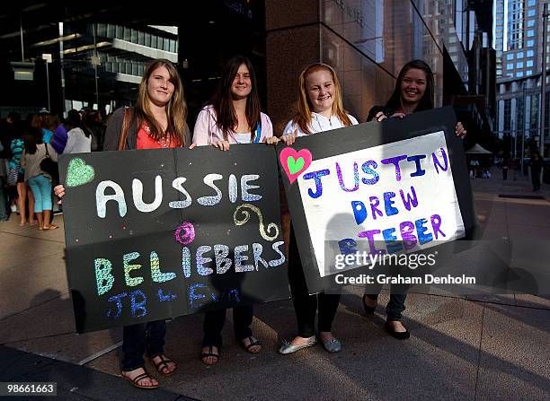 Justin Bieber fans pose with banners during the "Sunrise" broadcast at Martin Place on April 26, 2010 in Sydney, Australia. Bieber had been scheduled...