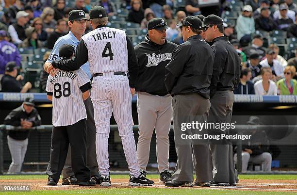 Logan McGregor the son of Keli McGregor joins manager Jim Tracy of the Colorado Rockies to present the line up to manager Fredi Gonzalez of the...