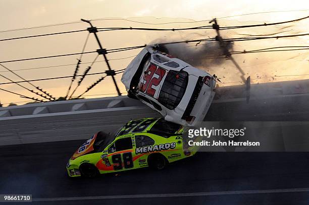 Dennis Setzer, driver of the K-Automotive Dodge, goes airborn over Paul Menard, driver of the Tide/Menards Ford, after an incident on track during...