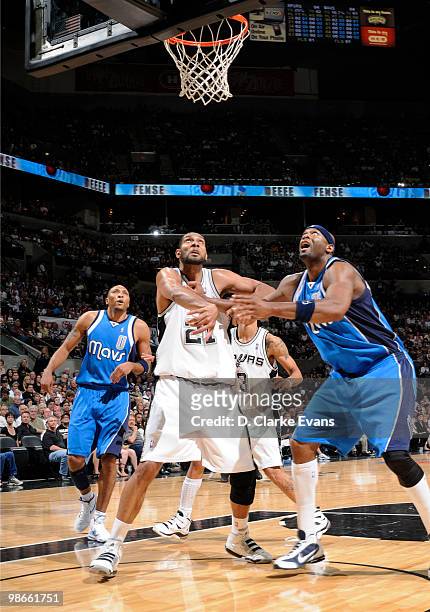 Tim Duncan of the San Antonio Spurs defends the basket against Erick Dampier of the Dallas Mavericks in Game Four of the Western Conference...