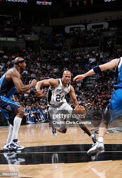 Richard Jefferson of the San Antonio Spurs drives thru Erick Dampier of the Dallas Mavericks in Game Four of the Western Conference Quarterfinals...