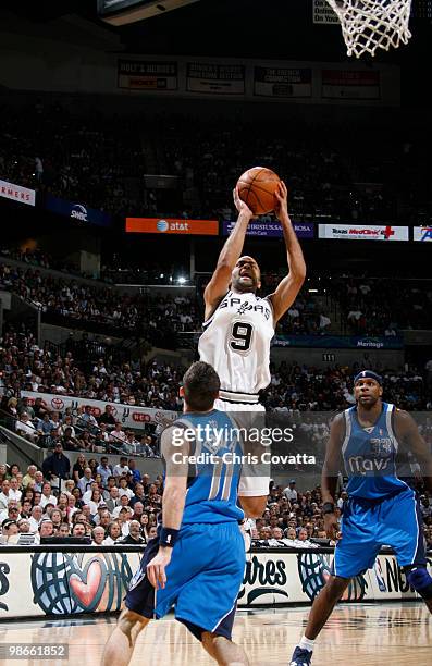 Tony Parker of the San Antonio Spurs shoots over Jose Juan Barea of the Dallas Mavericks in Game Four of the Western Conference Quarterfinals during...