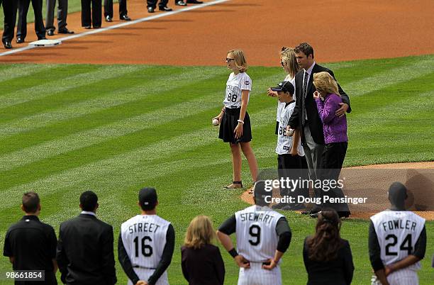 Lori McGregor, widow of Keli McGregor, joins her daughters Jordan, Taylor and Landri, and son, Logan, as they throw at the ceremonial first pitch...