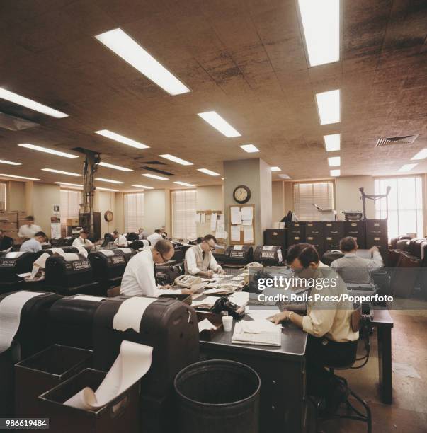 View of employees, journalists and clerks working in the news room at the United Press International news agency office in New York in 1970.