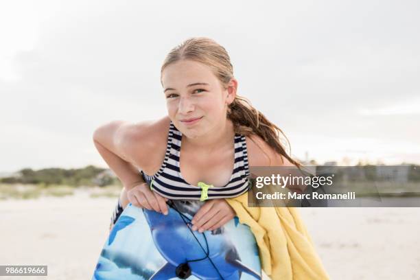 girl leaning on body board - marc romanelli stock pictures, royalty-free photos & images