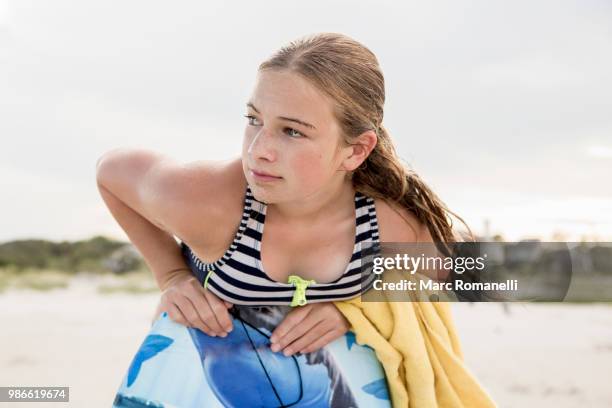 girl leaning on body board - marc romanelli stock pictures, royalty-free photos & images