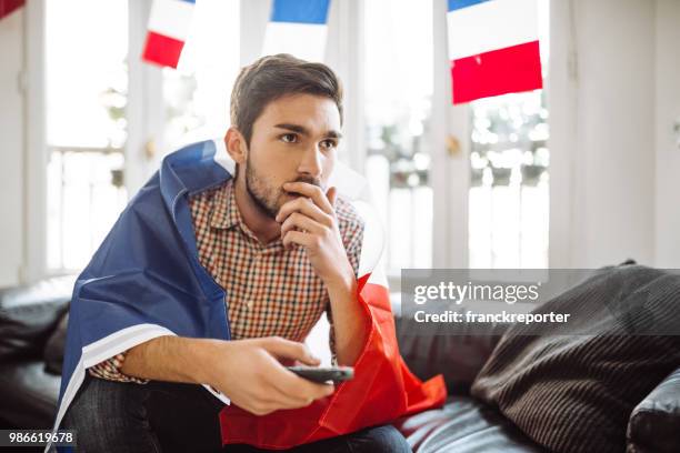 sad french supporter on the sofa - french tv stock pictures, royalty-free photos & images