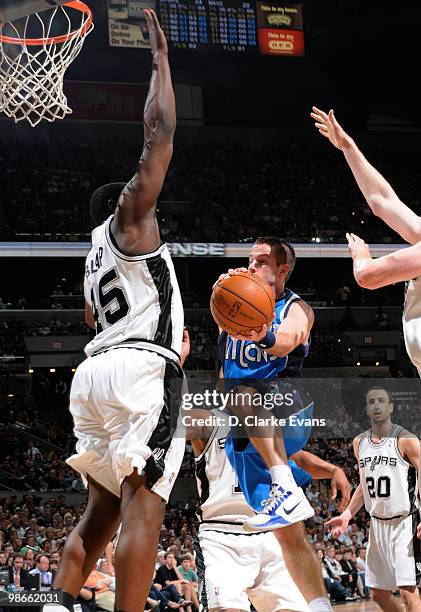 Jose Juan Barea of the Dallas Mavericks shoots against DeJuan Blair of the San Antonio Spurs in Game Four of the Western Conference Quarterfinals...