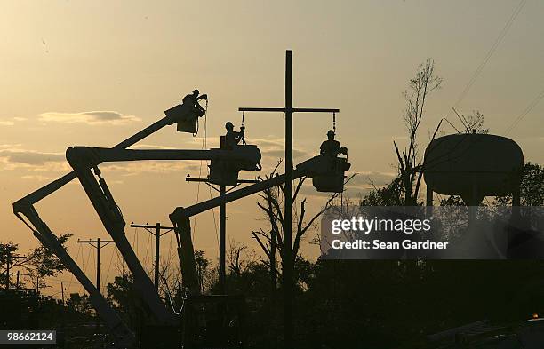 Electrical crews work late into the evening to restory power April 25, 2010 in Yazoo City, Mississippi. On Saturday a massive tonado hit the...