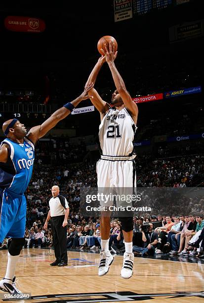 Tim Duncan of the San Antonio Spurs shoots over Erick Dampier of the Dallas Mavericks in Game Four of the Western Conference Quarterfinals during the...