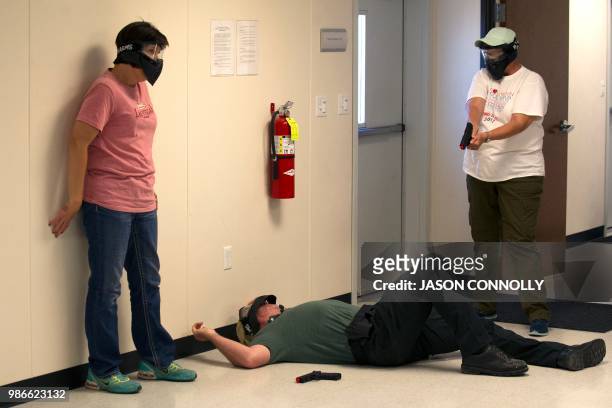 School teachers and administrators participate in an Airsoft mock active shooter drill during a three day firearms course sponsored by FASTER...