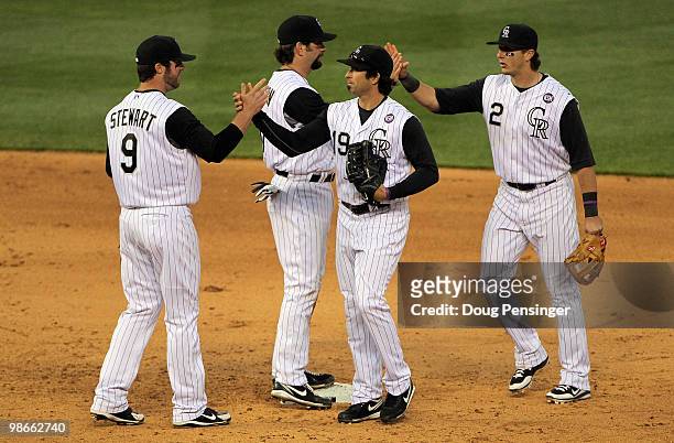 Ian Stewart, Todd Helton, Ryan Spilborghs and Troy Tulowitzki of the Colorado Rockies celebrate their 8-4 victory over the Florida Marlins at Coors...