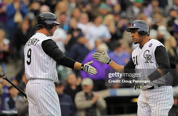 Catcher Miguel Olivo of the Colorado Rockies is welcomed home by Ian Stewart after his homerun against the Florida Marlins at Coors Field on April...