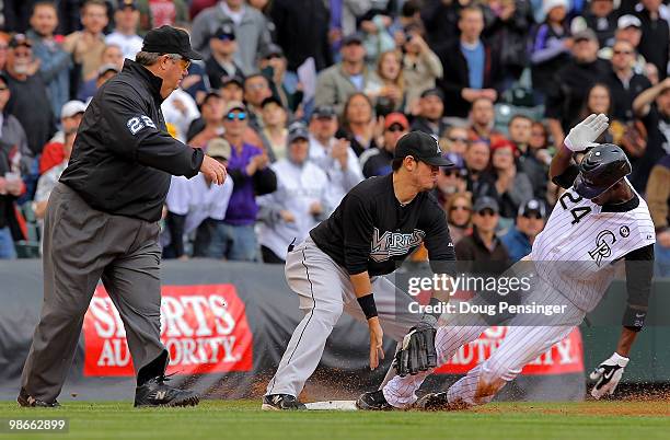 Dexter Fowler of the Colorado Rockies slides into third with an RBI triple as third baseman Jorge Cantu of the Florida Marlins is unable to handle...