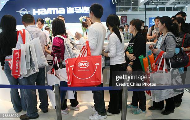 Visitor line up to get free gifts during the Beijing Auto Show on April 25, 2010 in Beijing of China. Major global automakers plan to unveil dozens...
