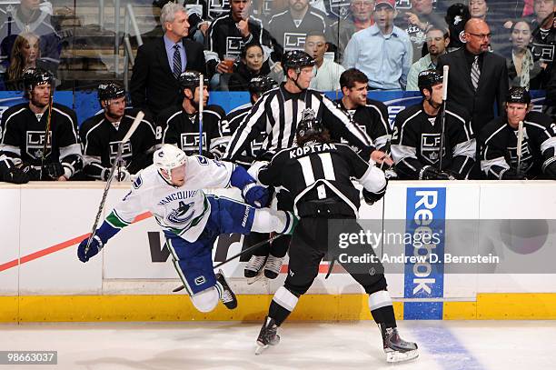 Anze Kopitar of the Los Angeles Kings throws the check against Daniel Sedin of the Vancouver Canucks in Game Six of the Western Conference...