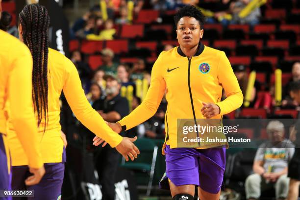 Alana Beard of the Los Angeles Sparks high-fives teammates as she enters the court on June 28, 2018 at Key Arena in Seattle, Washington. NOTE TO...