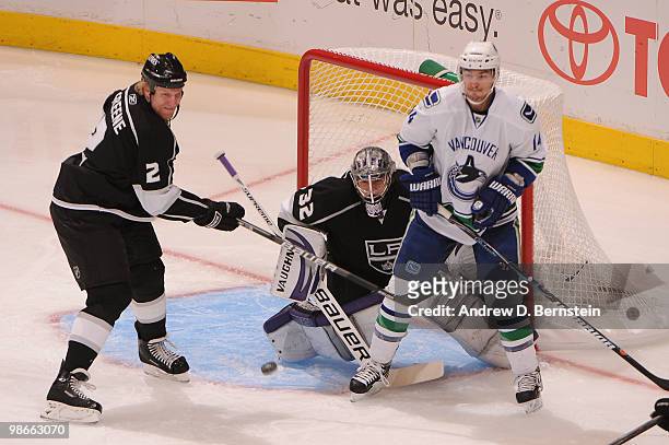 Jonathan Quick of the Los Angeles Kings makes the save as his teammate Matt Greene plays defense against Alexandre burrows of the Vancouver Canucks...