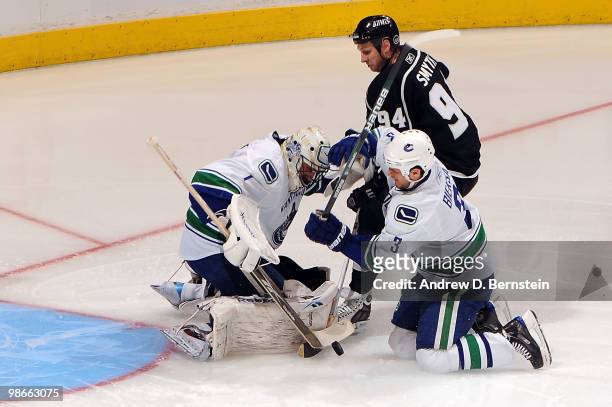 Ryan Smyth of the Los Angeles Kings battles for the puck against Roberto Luongo and Kevin Bieksa of the Vancouver Canucks in Game Six of the Western...