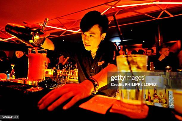 China-Expo2010-tourism-entertainment BY Joëlle GARRUS A barman prepares a cocktail in a trendy bar of Shanghai on April 16, 2010. Shanghai, the...