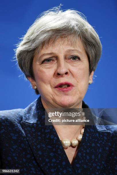 February 2018, Berlin, Germany: Great Britains Prime Minister Theresa May partakes in a press conference with German chancellor Angela Merkel after a...