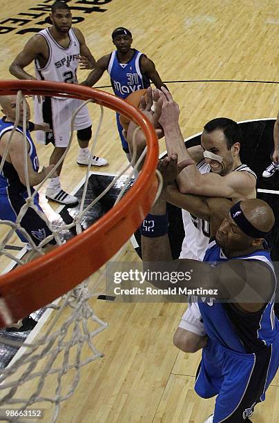 Guard Manu Ginobili of the San Antonio Spurs takes a shot against Erick Dampier of the Dallas Mavericks in Game Four of the Western Conference...