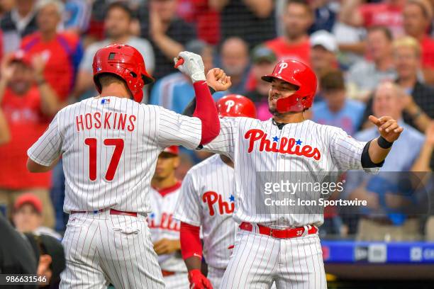 Philadelphia Phillies first baseman Carlos Santana greets Philadelphia Phillies left fielder Rhys Hoskins at home and celebrates his home run during...