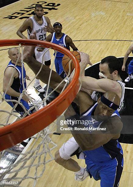 Guard Manu Ginobili of the San Antonio Spurs takes a shot against Erick Dampier of the Dallas Mavericks in Game Four of the Western Conference...