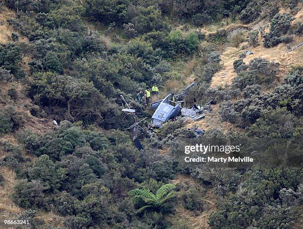 Air crash inspectors look over the wreckage of the Air Force Iroqouis Helicopter that crashed in the hills surrounding Pukerua Bay on April 25, 2010...