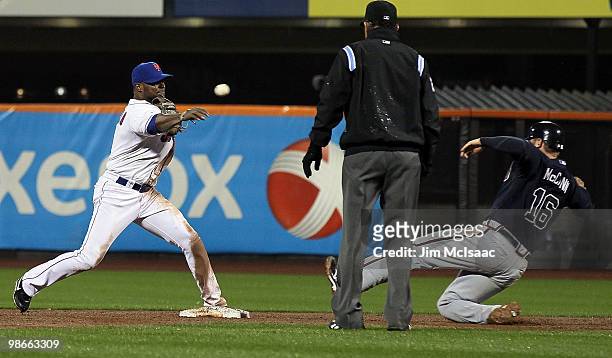 Luis Castillo of the New York Mets throws to first base to complete a fifth inning ending double play after forcing out Brian McCann of the Atlanta...