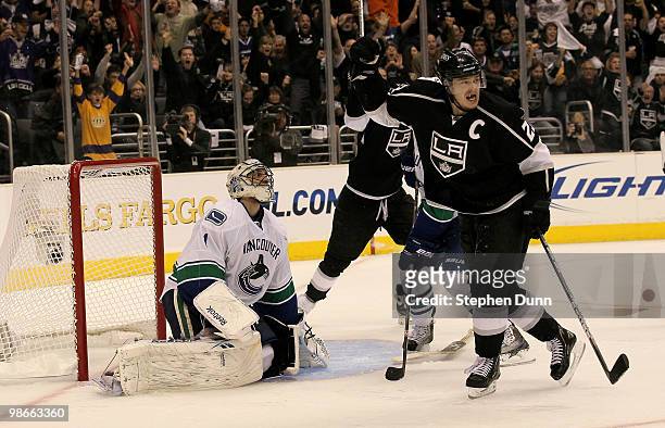 Dustin Brown of the Los Angeles Kings celebrates after a goal by Drew Doughty gets by goaltender Roberto Longo of the Vancouver Canucks in the second...