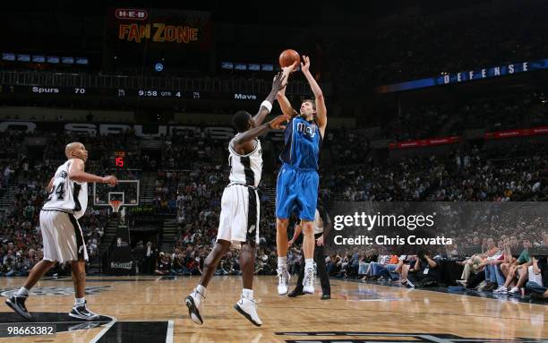 Dirk Nowitzki of the Dallas Mavericks shoots over Antonio McDyess of the San Antonio Spurs in Game Four of the Western Conference Quarterfinals...