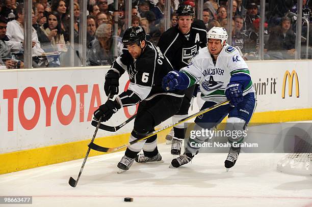 Sean O'Donnell of the Los Angeles Kings battles for the puck against Kyle Wellwood of the Vancouver Canucks in Game Six of the Western Conference...