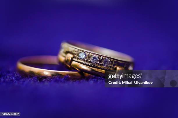 two gold wedding rings on dark background. macro photo - bringing home the bacon stock pictures, royalty-free photos & images