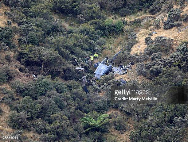 Air crash inspectors look over the wreckage of the Air Force Iroqouis Helicopter that crashed in the hills surrounding Pukerua Bay on April 25, 2010...