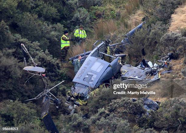 Air crash inspectors look over the wreckage of the Air Force Iroqouis Helicopter that crashed in the hills surrounding Pukerua Bay on April 25, 2010...