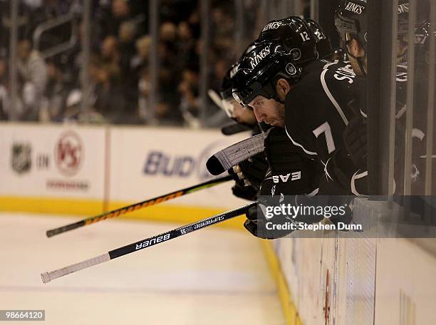 Rob Scuderi of the Los Angeles Kings sits on the bench with teammates during the last minute of the final period against the Vancouver Canucks during...