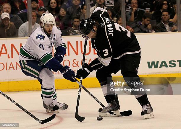 Jack Johnson of the Los Angeles Kings battles for the puck with Ryan Kesler of the Vancouver Canucks during Game Six of the Western Conference...